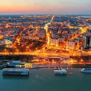 Galati, ROMANIA - March 19, 2021: Aerial view of Galati City, Romania. Danube River near city with sunset warm light
