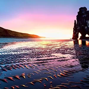 Incredible sunset landscape with famous Hvitserkur rock and dark sand after the tide. Vatnsnes peninsula, Iceland, Europe