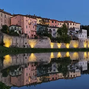 Old italian city reflection in Tevere river, Umbertide, Italy