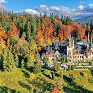 Peles Castle, Sinaia, Prahova County, Romania: Drone view of famous Neo-Renaissance castle in autumn colours, at the base of the Carpathian Mountains