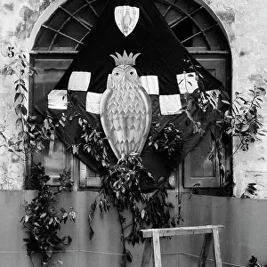"Contrada della Civetta". The photograph shows the banner of Contrada della Civetta in Siena. The flag is hanging in front of a door