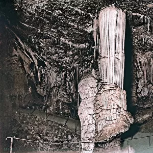 A huge stalactite united with a stalagmite, inside the cave of Adler, in Adelsberg, in Germany