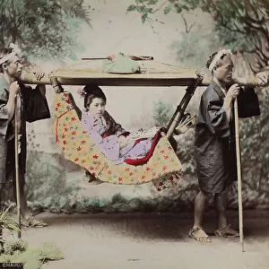 Two Japanese kago (sedan chair) bearers, transporting a woman