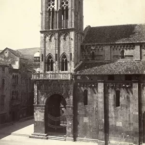 Partial view of a gothic bell tower and side wall of a church