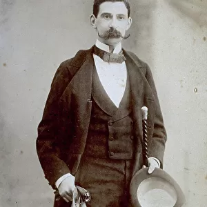Three-quarter length portrait of a young man in elegant late nineteenth century attire