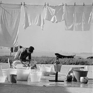 Woman washing laundry in the open air