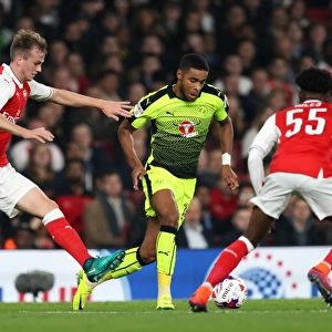 Intense Battle for the Ball: Holding vs. Samuel in Arsenal's EFL Cup Clash