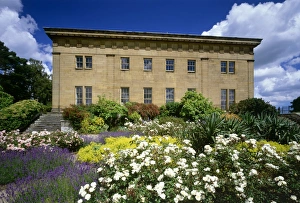 <b class=qtipBold><figcaption>Belsay Hall K021999</figcaption></b><br>BELSAY HALL & GARDENS, Northumberland. Garden (south) front of Belsay Hall with flower beds in foreground.<br><em>© Historic England</em> Belsay Hall K021999