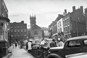 <b class=qtipBold><figcaption>Bewdley GOM01_05_050_27</figcaption></b><br>Bewdley, Worcestershire. A view looking west along Load Street towards St Anne's Church with cars and motorbikes parked in the foreground. Photographed by Andor Gomme in September 1957.<br><em>© Historic England Archive</em> Bewdley GOM01_05_050_27