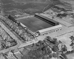 <b class=qtipBold><figcaption>Boscombe Football Ground EPR002704</figcaption></b><br>Boscombe Football Ground, or Dean Court, Bournemouth. Home of Bournemouth and Boscombe Athletic Football Club, who have since become AFC Bournemouth. Aerial view by Aeropictorial. May 1937. Aerofilms Collection.<br><em>© Historic England</em> Boscombe Football Ground EPR002704