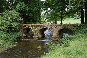 <b class=qtipBold><figcaption>Bow Bridge, Cumbria K930419</figcaption></b><br>BOW BRIDGE, Barrow-in-Furness, Cumbria. View of the bridge looking North. This narrow 15th century stone bridge across Mill Beck carried an old packhorse route to nearby Furness Abbey.<br><em>© Historic England</em> Bow Bridge, Cumbria K930419
