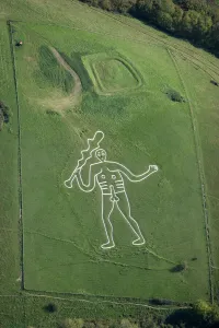 <b class=qtipBold><figcaption>Cerne Abbas Giant 26127_047</figcaption></b><br>CERNE ABBAS GIANT, Dorset, in the care of the National Trust. Aerial view. The giant's origin is uncertain, although one theory is that he was cut to represent "England's Hercules", as a parody of Oliver Cromwell. The rectangular earthwork above the giant is known as the Trendle, an Iron Age enclosure possibly for a farmstead. In the 19th century the earthwork was traditionally used as the setting for a Maypole.<br><em>© Historic England</em> Cerne Abbas Giant 26127_047