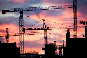 <b class=qtipBold><figcaption>Cranes N071033</figcaption></b><br>Urban landscape. A building site at sunset with cranes against a red sky.<br><em>© Historic England</em> Cranes N071033