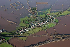 <b class=qtipBold><figcaption>East Lyng flooding 27897_016</figcaption></b><br>East Lyng, Somerset. At the end of the 9th century AD King Alfred the Great established a burh, or fortified settlement, at the eastern end of the Lyng ridge. The town was linked to the nearby stronghold and monastery at Athelney, founded by Alfred a few years earlier, and all were surrounded by the marshes of the Somerset Levels. This image, taken at the height of the flooding in the winter of 2013/14, shows the logic behind the location of the settlement, now called East Lyng. Digital photograph taken in 2014.<br><em>© Historic England</em> East Lyng flooding 27897_016
