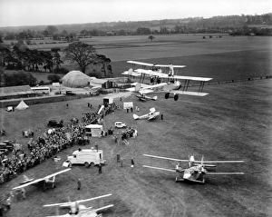 <b class=qtipBold><figcaption>Flying circus EPW041022</figcaption></b><br>Flying circus, April 1933. Aviation events like this one were popular entertainments between the wars, including aerobatics, barnstorming and wing-walking (as seen here). In 1933 the UK Civil Aviation Authority banned wing-walking without a rigid harness, so this photograph must have been taken shortly before the ban. Aerofilms Collection (see Links).<br><em>© Historic England</em> Flying circus EPW041022