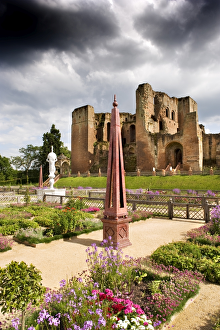 <b class=qtipBold><figcaption>Kenilworth Castle N090510</figcaption></b><br>KENILWORTH CASTLE, Warwickshire. The north facade of the great tower viewed from across the Elizabethan garden. Bedding plants, obelisks and marble fountain under a stormy sky.<br><em>© Historic England</em> Kenilworth Castle N090510
