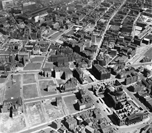 <b class=qtipBold><figcaption>Liverpool, 1946 EAW001911</figcaption></b><br>LIVERPOOL. Aerial view, 12th July 1946, showing the area around the five way junction of Duke Street, Hanover Street and Paradise Street (the former Sailors Home, now demolished, stands at the junction) in July 1946. The widespread devastation caused by bombing during the Second World War is apparent. Liverpool Old Custom House on Canning Place stands roofless in the foreground after firebomb damage in the Liverpool blitz of 1941. It was demolished in 1950. Some whole blocks in the area around South John Street have been cleared and levelled ready for redevelopment. Most of this network of streets are now occupied by Chavasse Park, the Moat House Hotel and the Bus Station. Aerofilms Collection (see Links).<br><em>© Historic England</em> Liverpool, 1946 EAW001911