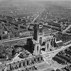<b class=qtipBold><figcaption>Liverpool Cathedral EAW023367</figcaption></b><br>LIVERPOOL CATHEDRAL. The Anglican Cathedral in Liverpool was begun in 1904 to a design of Giles Gilbert Scott. The tower was completed in 1942, but the cathedral was not completed until 1978. Seen here from the air in 1949, the nave and west front are still to be completed. Aerofilms Collection (see Links).<br><em>© Historic England</em> Liverpool Cathedral EAW023367