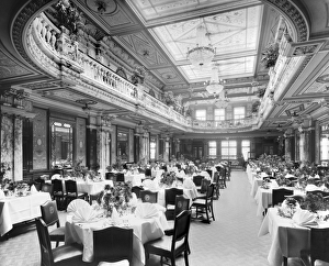 <b class=qtipBold><figcaption>Lyons Popular Cafe BL18609</figcaption></b><br>THE POPULAR CAFE, Piccadilly, London. Restaurant interior from the entrance with tables set and ready for customers. The start of a new restaurant venture for Lyons, the Popular Cafe opened to the public on 10 October 1904 with seating for 2000. This is where the band leader Victor Sylvester started his career by providng musical accompaniment for the diners every afternoon. It closed in July 1939 at the outset of the second world war. Photographed by Bedford Lemere for J Lyons & Co a few days before the grand opening.<br><em>© Historic England</em> Lyons Popular Cafe BL18609
