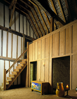 <b class=qtipBold><figcaption>Medieval Merchants House J880161</figcaption></b><br>MEDIEVAL MERCHANT'S HOUSE, Southampton, Hampshire. Interior view of the hall showing stairs to the first floor bedchambers.<br><em>© Historic England</em> Medieval Merchants House J880161