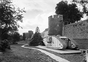 <b class=qtipBold><figcaption>Memorial Tank WSA01_01_GG0087</figcaption></b><br>City Walls, Canterbury, Canterbury, Kent. The First World War tank was presented to Canterbury in July 1919 to celebrate the 'Great Peace Day'. 1920-1940. Walter Scott.<br><em>© Historic England Archive</em> Memorial Tank WSA01_01_GG0087