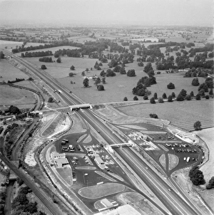 <b class=qtipBold><figcaption>Motorway Services 1961 EAW094297</figcaption></b><br>M1 MOTORWAY. Aerial view of the motorway and the service station at Newport Pagnell, after opening to all traffic in 1960. This was the second motorway service station built in England, but the first to accomodate cars. Photograph taken in July 1961. Aerofilms Collection (see Links).<br><em>© Historic England Aeroflims Collection</em> Motorway Services 1961 EAW094297