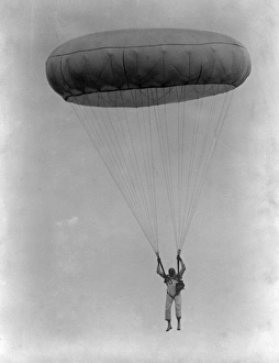 <b class=qtipBold><figcaption>Parachutist AFL03_aerofilms_b251</figcaption></b><br>Parachutist descending 1930s. Canopy fully open. Aerofilms Collection (see Links).<br><em>© Historic England</em> Parachutist AFL03_aerofilms_b251