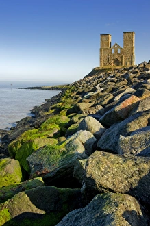 <b class=qtipBold><figcaption>Reculver Towers N100066</figcaption></b><br>RECULVER TOWERS AND ROMAN FORT, Kent. View of the twin towers with rocks of hard coastal defences in the foreground.<br><em>© Historic England</em> Reculver Towers N100066