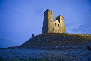 <b class=qtipBold><figcaption>Reculver Towers N100071</figcaption></b><br>RECULVER TOWERS AND ROMAN FORT, Kent. Floodlit view of the towers.<br><em>© Historic England</em> Reculver Towers N100071