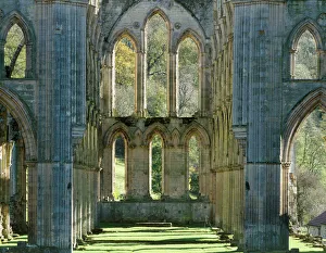 <b class=qtipBold><figcaption>Rievaulx Abbey J070049</figcaption></b><br>RIEVAULX ABBEY, North Yorkshire. The window at the east end of the abbey church showing autumn colour on the trees beyond.<br><em>© Historic England</em> Rievaulx Abbey J070049