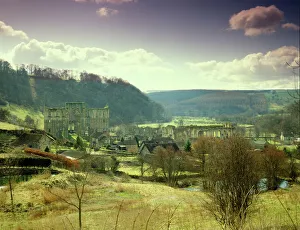 <b class=qtipBold><figcaption>Rievaulx Abbey J870076</figcaption></b><br>RIEVAULX ABBEY, North Yorkshire. Winter view from the hillside.<br><em>© Historic England</em> Rievaulx Abbey J870076