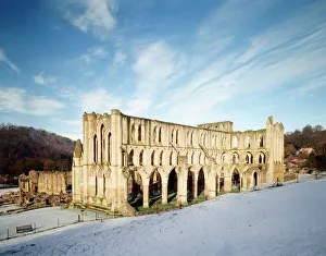 <b class=qtipBold><figcaption>Rievaulx Abbey J980028</figcaption></b><br>RIEVAULX ABBEY, North Yorkshire. The abbey church from the North East with snow.<br><em>© Paul Highnam</em> Rievaulx Abbey J980028