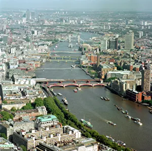 <b class=qtipBold><figcaption>River Thames 21760_09</figcaption></b><br>RIVER THAMES, London. Aerial view. The River Thames has always been of major importance to the City of London. It provided water (of varying quality), and a means of transportation and communication. The first bridge across the river was built by the Romans shortly after the invasion of AD43. This picture shows a series of bridges between Tower Bridge and Blackfriars Bridge. Between London Bridge and Tower Bridge is the cruiser HMS Belfast. In the distance are the towers of Canary Wharf.<br><em>© Historic England</em> River Thames 21760_09