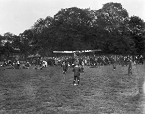 <b class=qtipBold><figcaption>A safe landing EPW005069</figcaption></b><br>REGENTS PARK. London. Aircraft landed in Regents Park, September 1920. The aeroplane, facing towards the trees, is surrounded by a crowd of excited onlookers, while two men shake hands. Aerofilms Collection (see Links).<br><em>© Historic England</em> A safe landing EPW005069