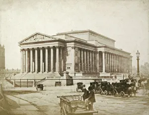 <b class=qtipBold><figcaption>St George's Hall OP02751</figcaption></b><br>St George's Hall, St George's Plateau, Liverpool, 1854-55. Attributed to Thomas Sutton (1819-75), salted paper print. Cabs stand outside the newly built neoclassical St George's Hall, designed by Harvey Lonsdale Elmes and completed by Charles Robert Cockerell. The building, combining a public hall and law courts, was erected between 1841 and 1856. The photograph is attributed to Thomas Sutton because the original mount bears the name of the Frenchman Louis-Desire Blanquart-Evrard, who published some of Sutton's negatives in 1854. Sutton and Blanquart-Evrard opened a printing establishment on Jersey in 1855, and launched the journal Photographic Notes the following year. Sutton was a prolific writer on photography, and published A Dictionary of Photography in 1858.<br><em>© Historic England</em> St George's Hall OP02751