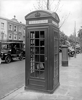 <b class=qtipBold><figcaption>Telephone box in 1926 BL28503</figcaption></b><br>TELEPHONE BOX, Ladbroke Grove, Kensington, London. An example of a new-issue K2 telephone kiosk in Ladbroke Grove. This style of telephone box was introduced in 1926, based on a design by Giles Gilbert Scott. A motor car and post box can be seen in the background. Photographed by Harry Bedford Lemere in 1926.<br><em>© Historic England</em> Telephone box in 1926 BL28503