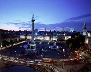 <b class=qtipBold><figcaption>Trafalgar Square J060220</figcaption></b><br>TRAFALGAR SQUARE, City of Westminster, London. An elevated view of the square showing Nelson's Column & the National Gallery at dusk / night.<br><em>© Historic England</em> Trafalgar Square J060220