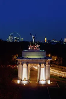 <b class=qtipBold><figcaption>Wellington Arch K050053</figcaption></b><br>THE WELLINGTON ARCH, Hyde Park Corner, London. A view from the Lanesborough Hotel of the arch floodlit at night with ' Big Ben ' and the London Eye wheel in the background.<br><em>© Historic England</em> Wellington Arch K050053