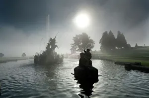 <b class=qtipBold><figcaption>Witley Court N071292</figcaption></b><br>WITLEY COURT AND GARDENS, Worcestershire. The sun shining through a veil of mist produced by the fountain.<br><em>© Historic England</em> Witley Court N071292