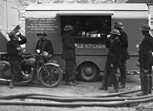 Enjoying Gallery: Firefighters outside mobile kitchen, WW2