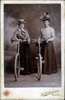 A splendid cabinet photograph of two well-dressed women standing proudly with their A splendid cabinet photograph of two well-dressed women standing proudly with their