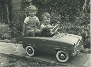 Twin Gallery: A twin brother and sister, wearing matching dungarees, play together in a splendid toy