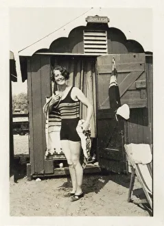 Swim Gallery: Woman drying herself after a dip in the sea outside her hut