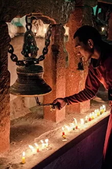 Religion & Spirituality Collection: A Buddhist monk rings a prayer bell during the full moon celebrations, Bodhnath stupa, Bodhnath