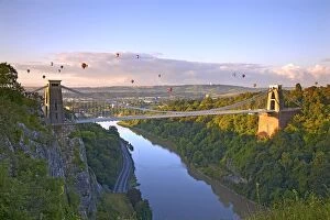 Cliff Collection: Clifton Suspension Bridge with hot air balloons in the Bristol Balloon Fiesta in August