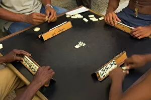 Four People Gallery: Close-up of the hands of a group of four people playing dominos in the street Centro Habana