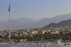 Seafront Gallery: Elevated view of Aqaba seafront with huge Jordanian flag, boats and hazy mountains in distance
