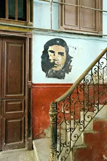 West Indian Gallery: Faded mural of Che Guevara on the staircase of a dilapidated apartment building