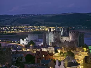 Flood Lit Collection: Floodlit Conwy Castle, UNESCO World Heritage Site, overlooking the town with the River Conwy