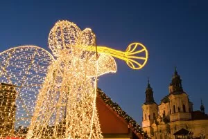 Glowing angel, part of Christmas decoration at Staromestske (Old Town Square) with Baroque St